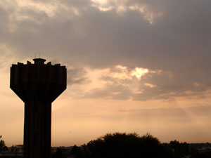 Sun, clouds, and water tank